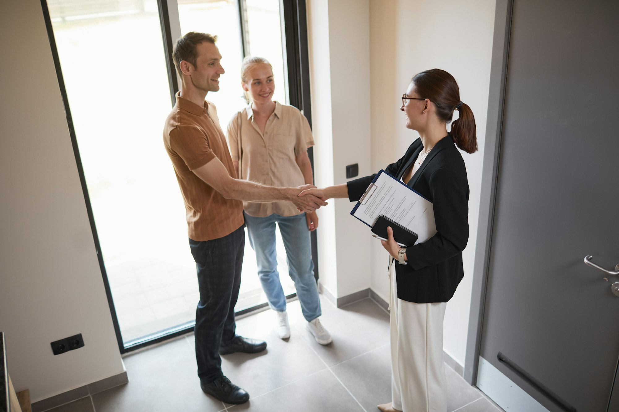 Couple Greeting Real Estate Agent
